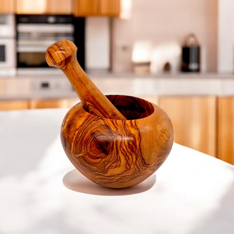Round olive wood mortar and pestle in a kitchen