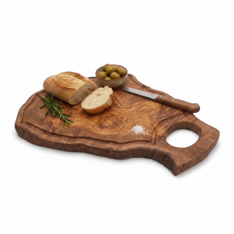 Natural olive wood chopping board with large handle and groove serving bread and olives