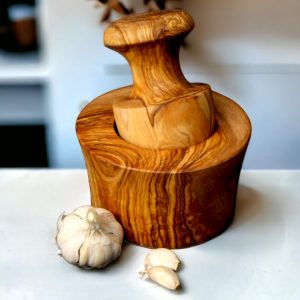 Olive Wood Garlic Mortar & Pestle with mushroom-shaped pestle and fresh garlic cloves