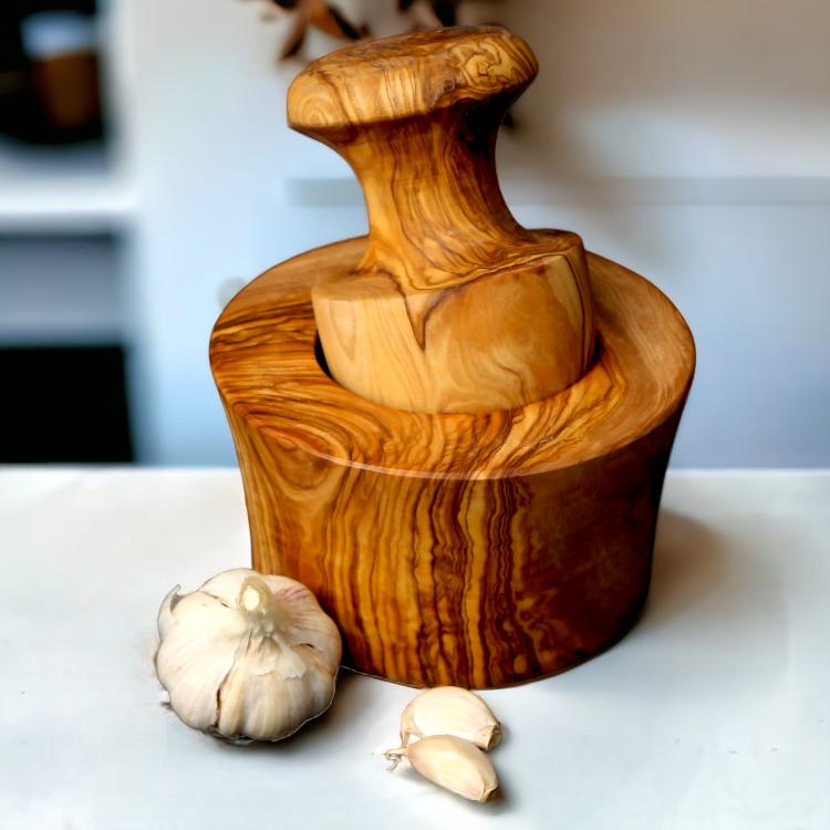 Olive Wood Garlic Mortar & Pestle with mushroom-shaped pestle and fresh garlic cloves