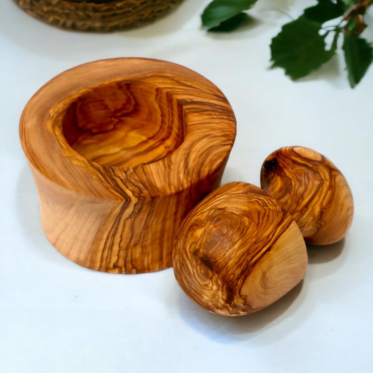 Overhead view of olive wood garlic mortar and pestle showing the deep grinding bowl and rounded pestle