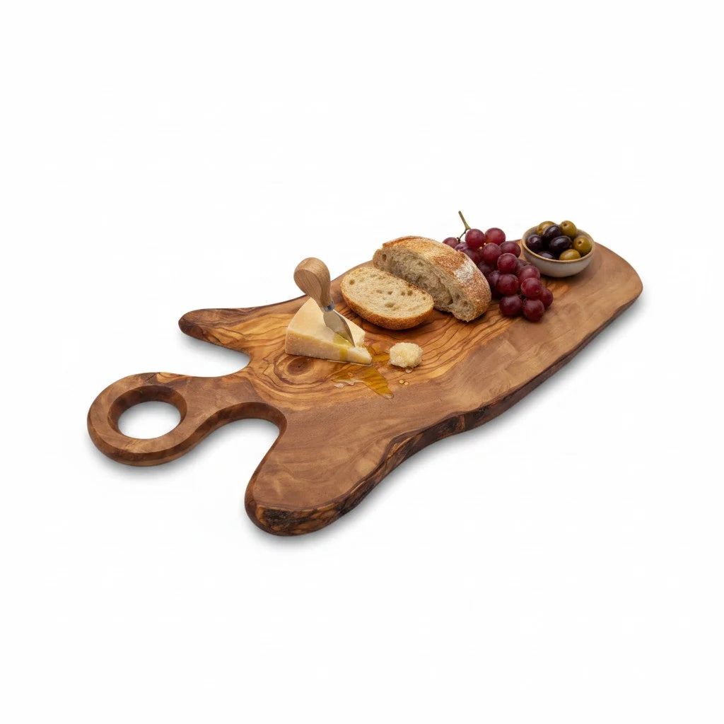 Olive wood freeform serving board with round handle displaying bread, cheese, grapes and olives
