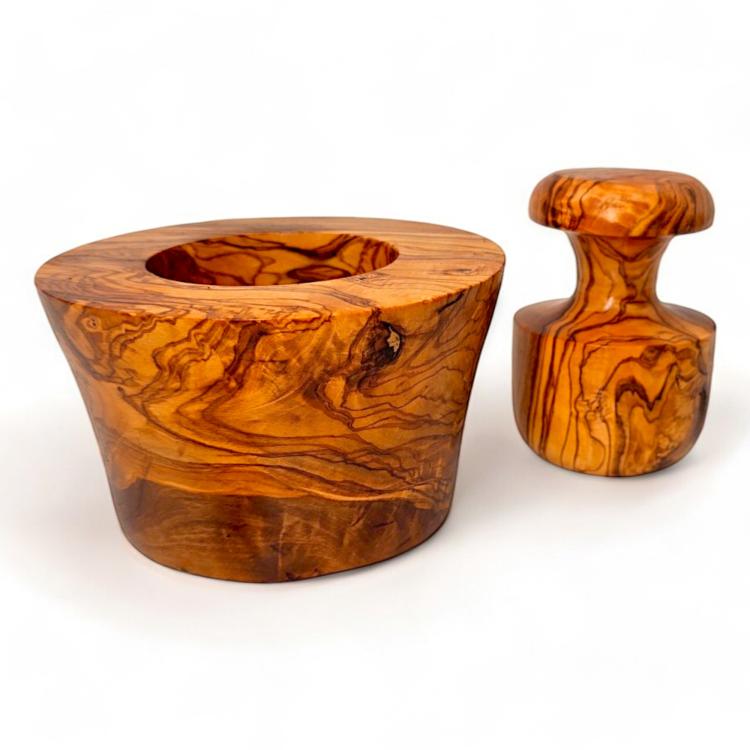 Olive wood garlic mortar and mushroom-shaped pestle displayed separately showing natural wood grain