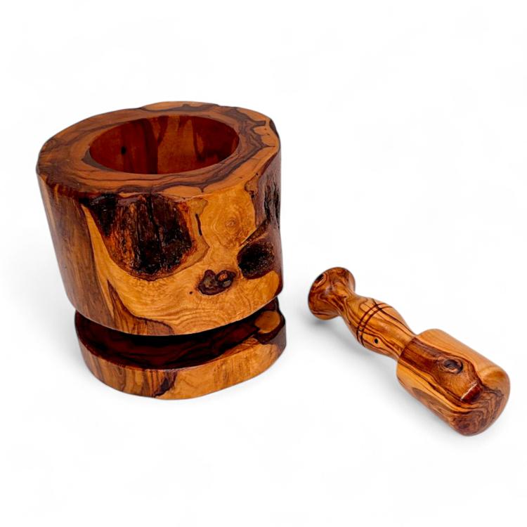 Olive wood rustic mortar on matching wooden base with pestle displayed alongside showing distinctive natural wood grain