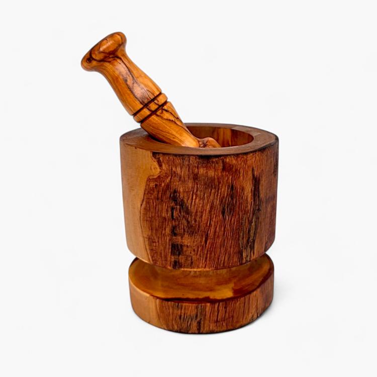 Olive wood rustic mortar and pestle with pestle resting inside the bowl on a separate wooden base